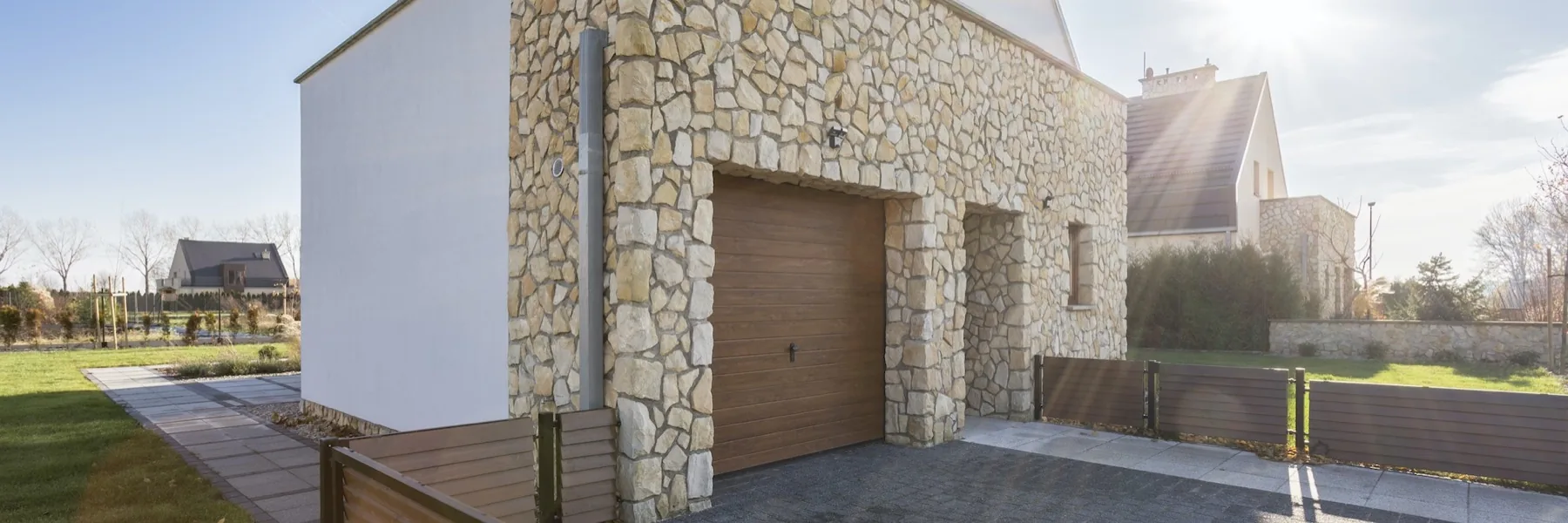 A detached garage structure with stone facade